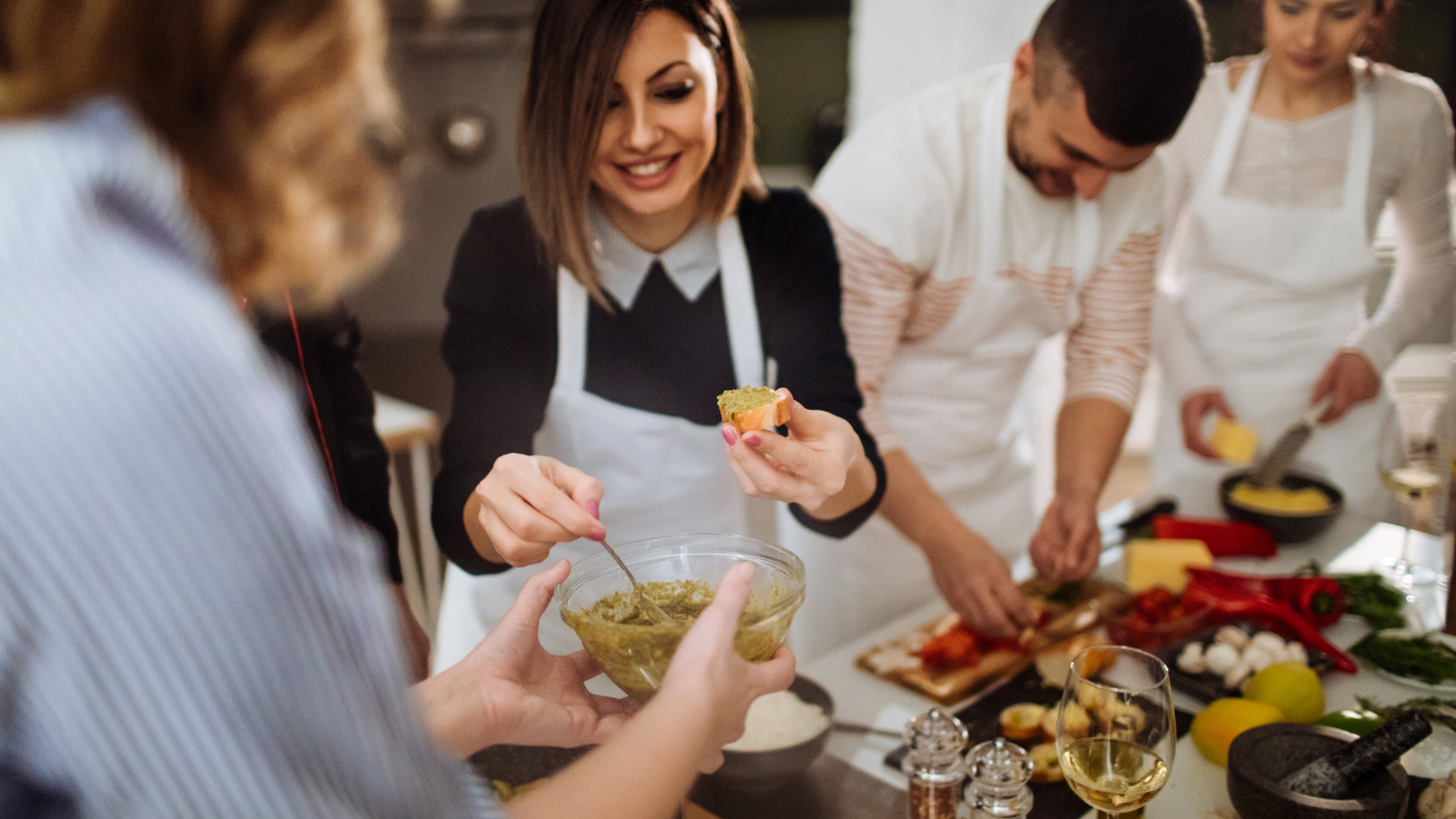 Group of people preparing and tasting food