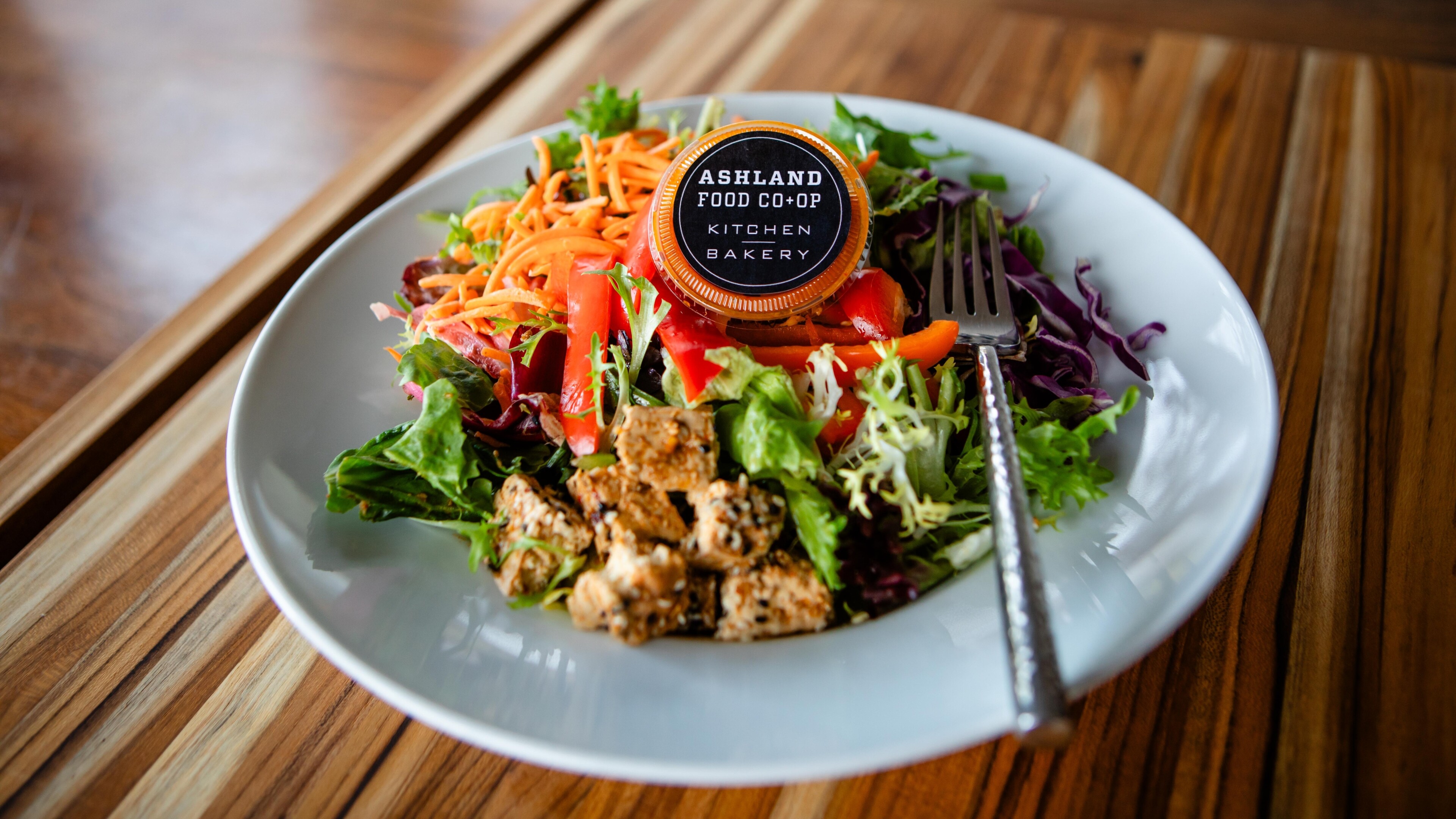 salad with tofu, carrots and peppers on a white plate