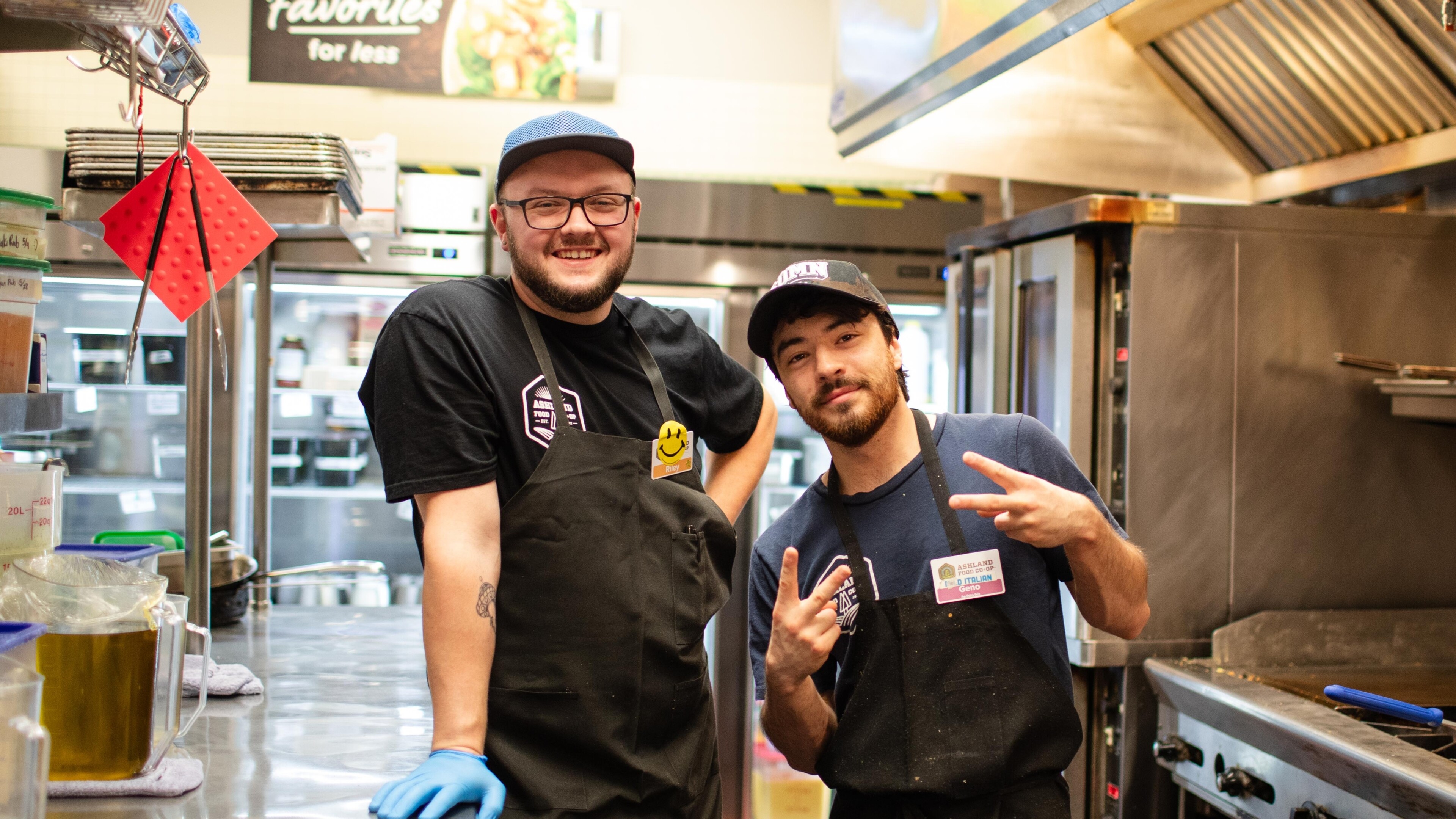 two men in aprons in a commerical kitchen