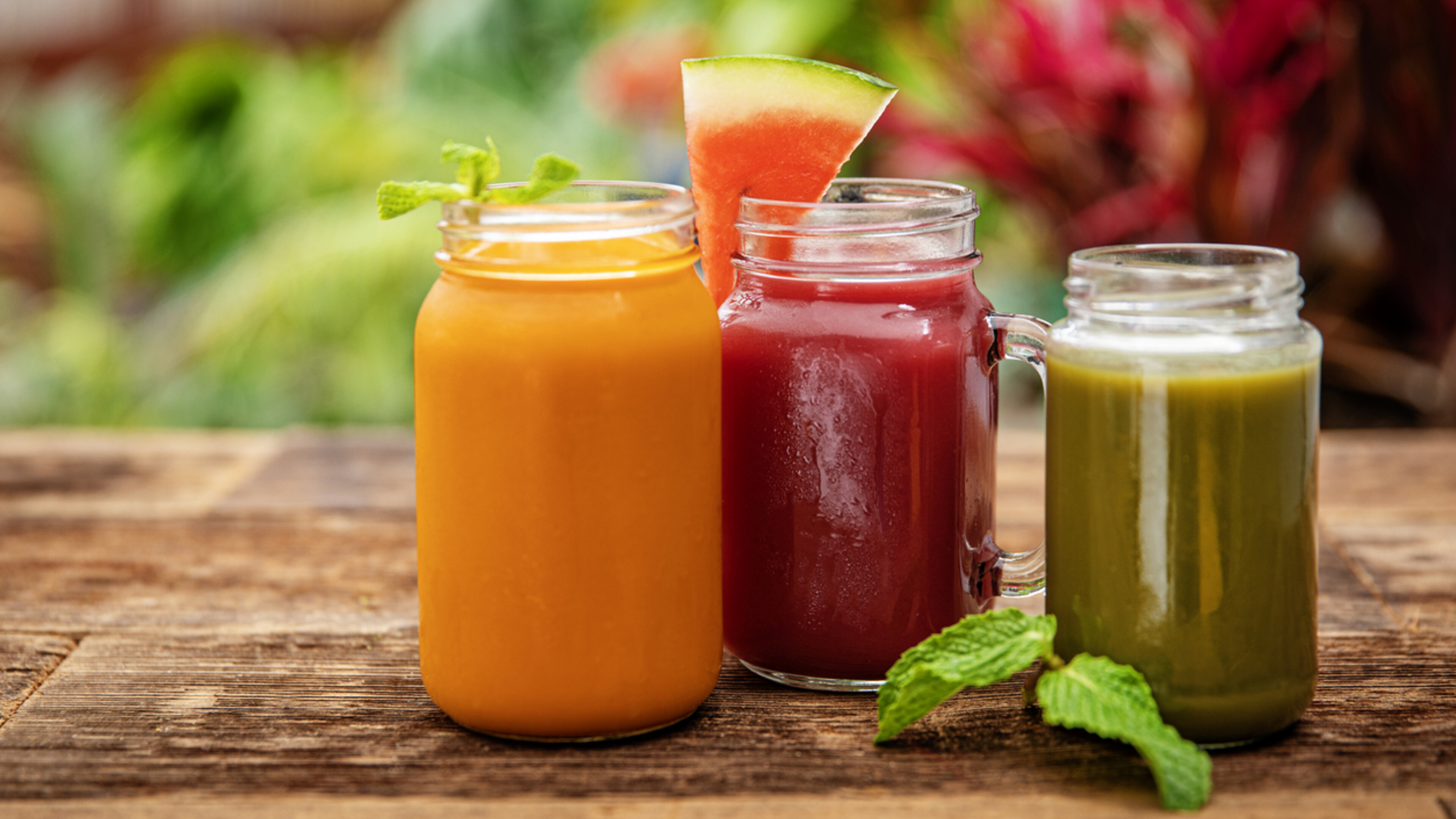 assortment of fresh juices in glass jars