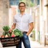 Jon Steinman poses with a grocery basket as a headshot. 