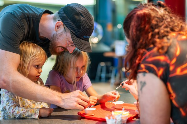 family doing a science experiment at scienceworks