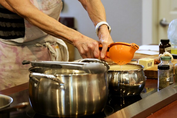 close up of hands using an orange squeezer