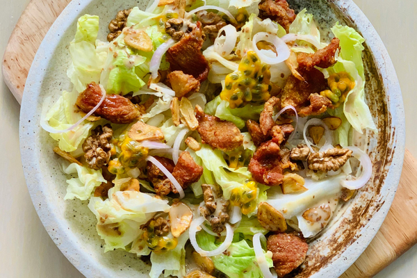taco salad in a white bowl on a cutting board