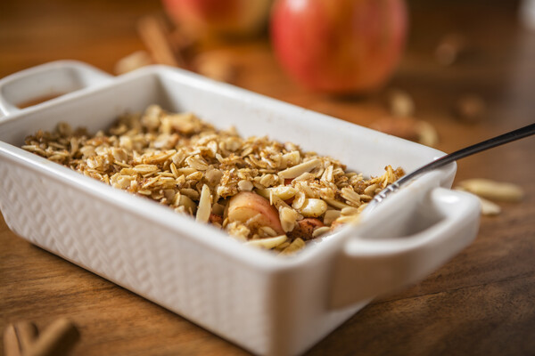 cinnamon apple pear crisp in a white ceramic dish