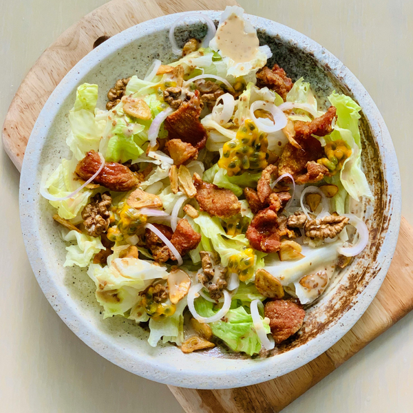 taco salad in a white bowl on a cutting board