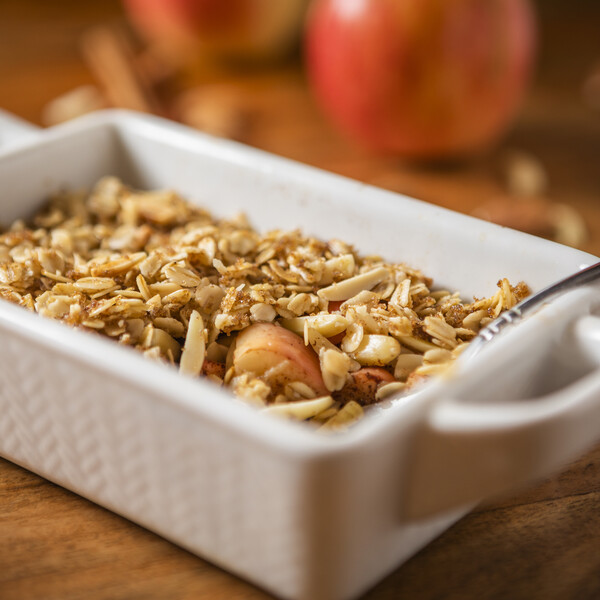 cinnamon apple pear crisp in a white ceramic dish